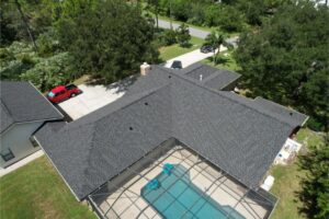 Aerial view of a house with a swimming pool in the backyard.