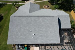 Aerial view of a large, gray shingled roof on a residential house.