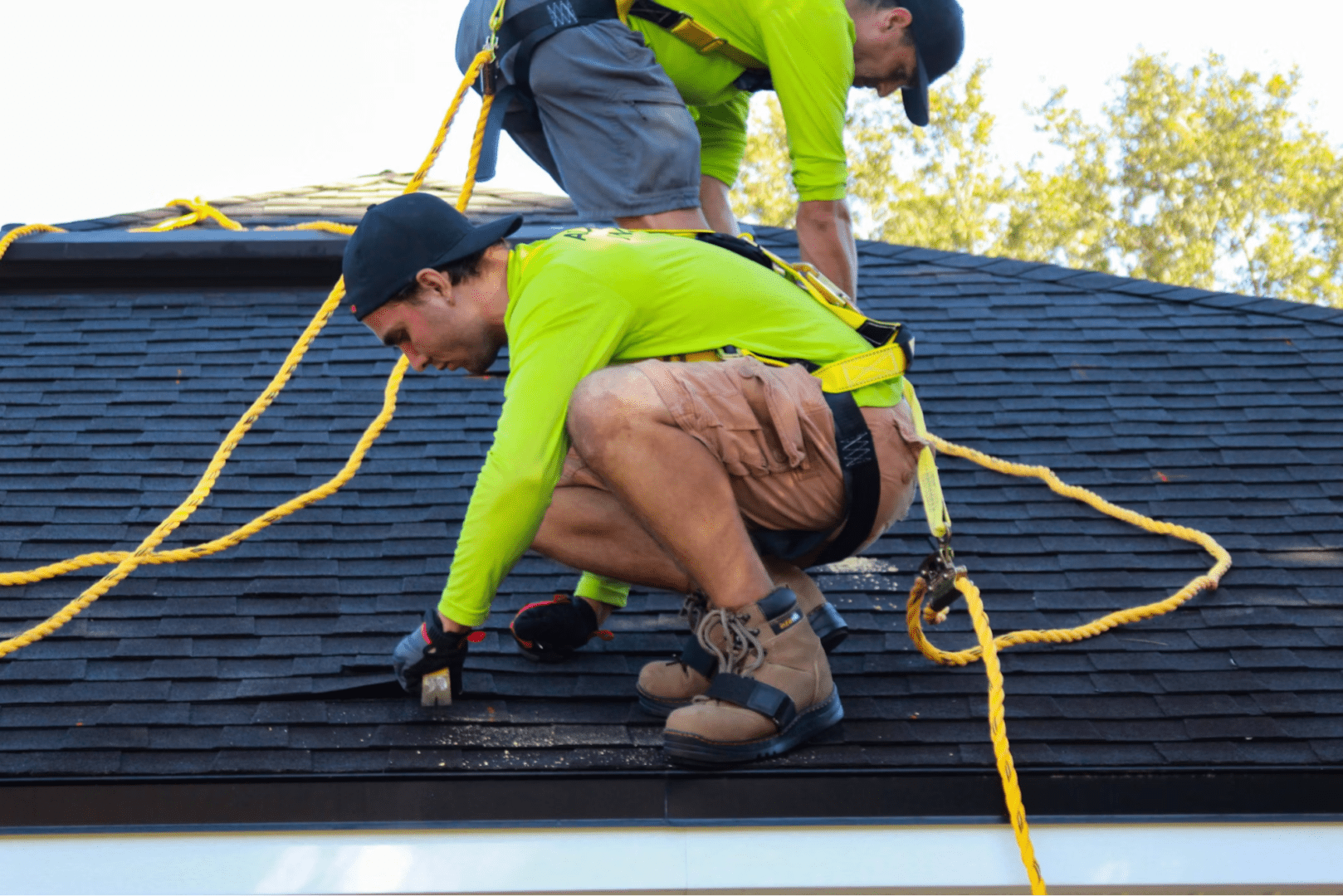 hardworking men installing roof of client