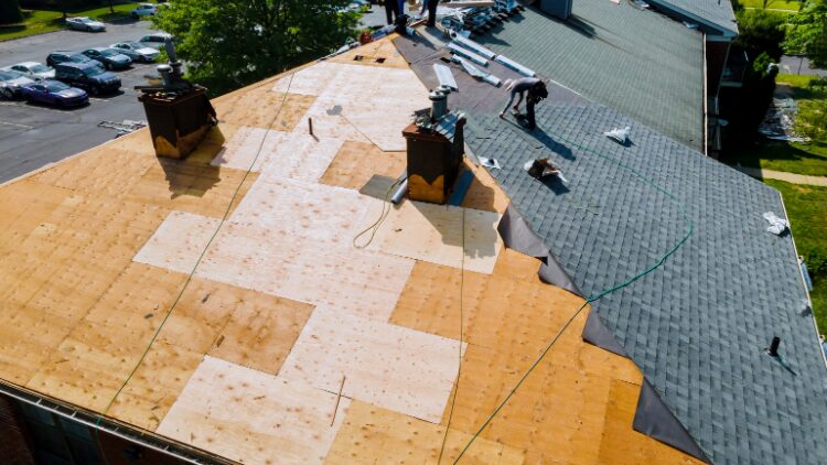 man fixing a house roof