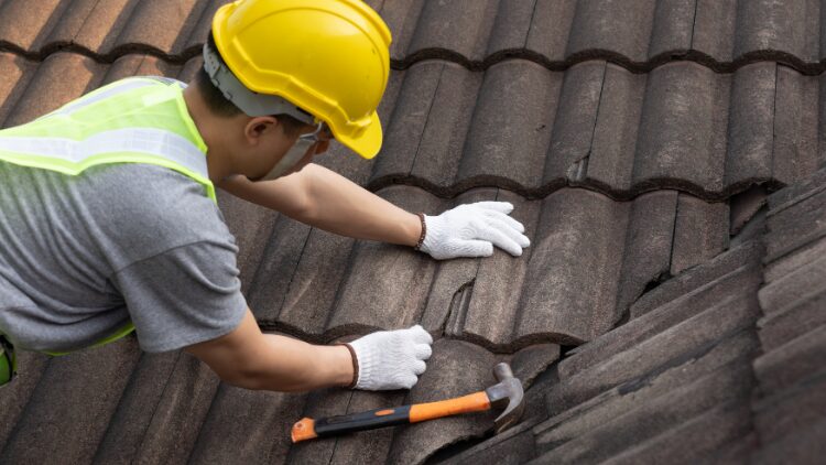 man fixing roof