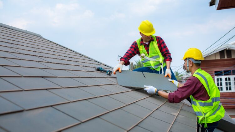 two men fixing roof