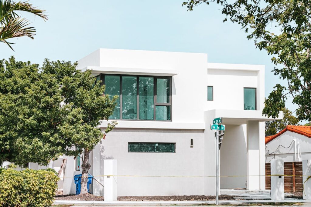 white concrete building near green tree