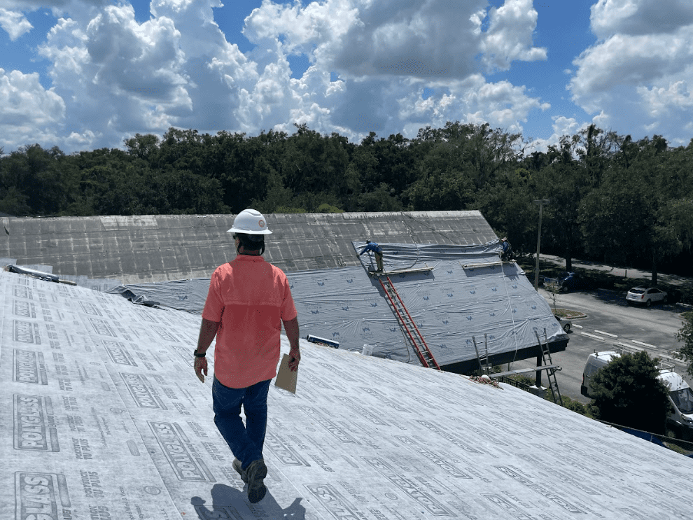 Roofer walking on top of a roof