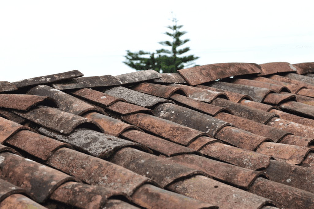 Close-up of faded and weathered roof shingles showing UV damage